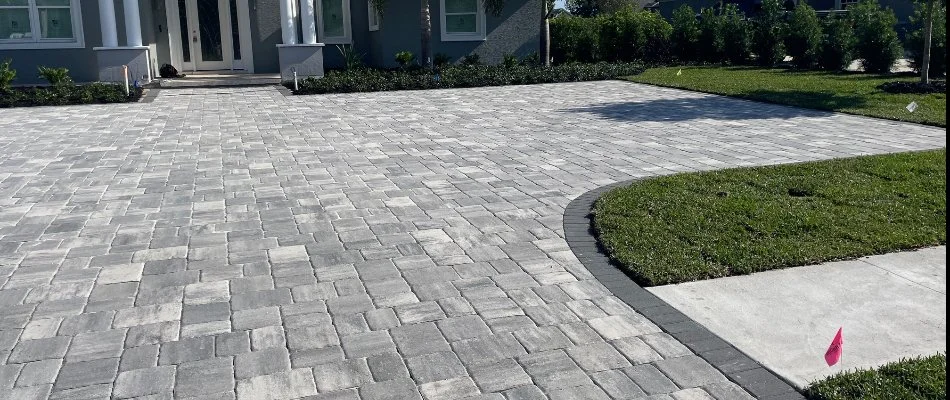 A paver patio in Winter Haven, FL, with surrounding landscaping and sod.