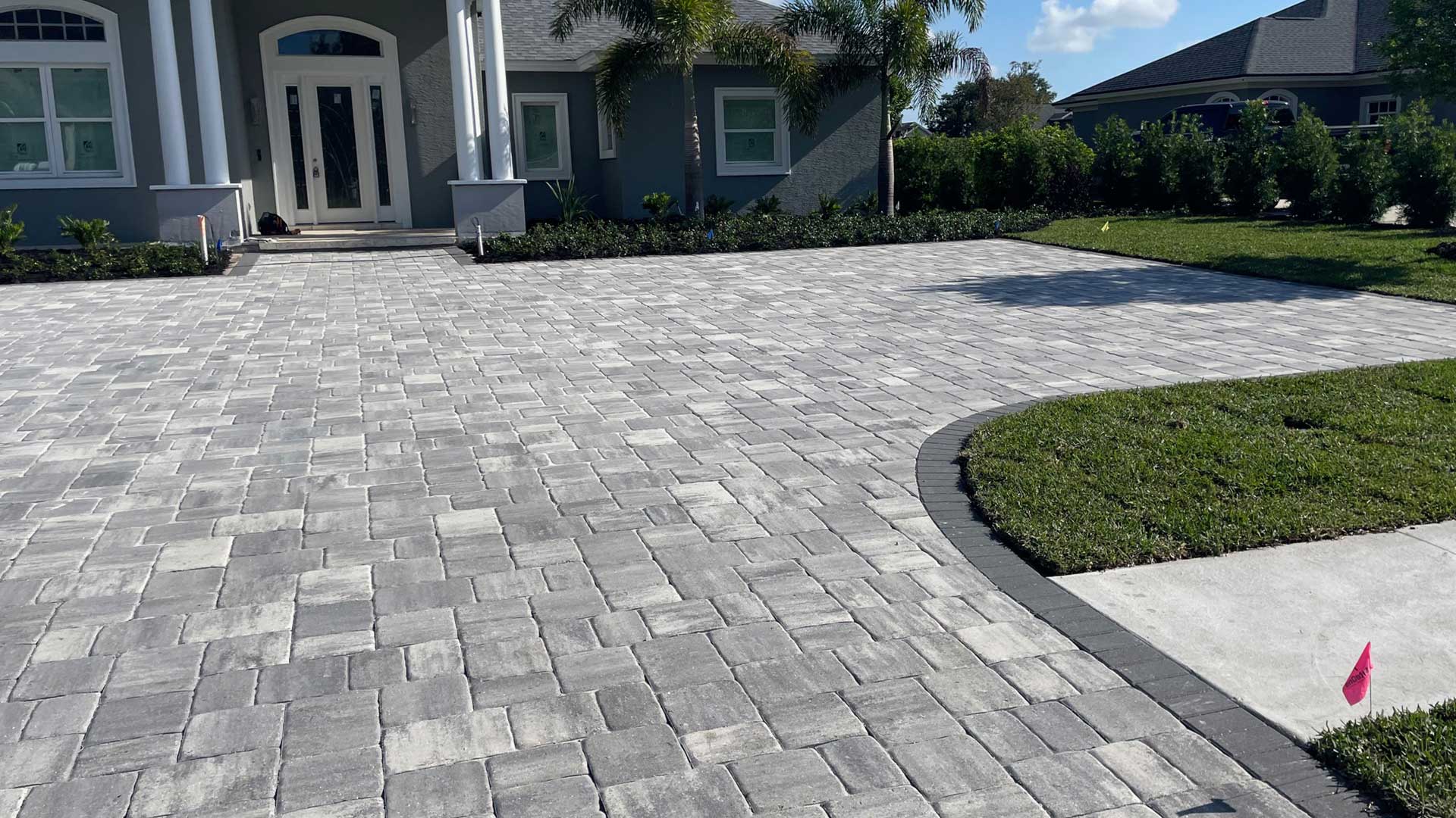 Custom gray paver patio and driveway at a residential property Lakeland, FL.